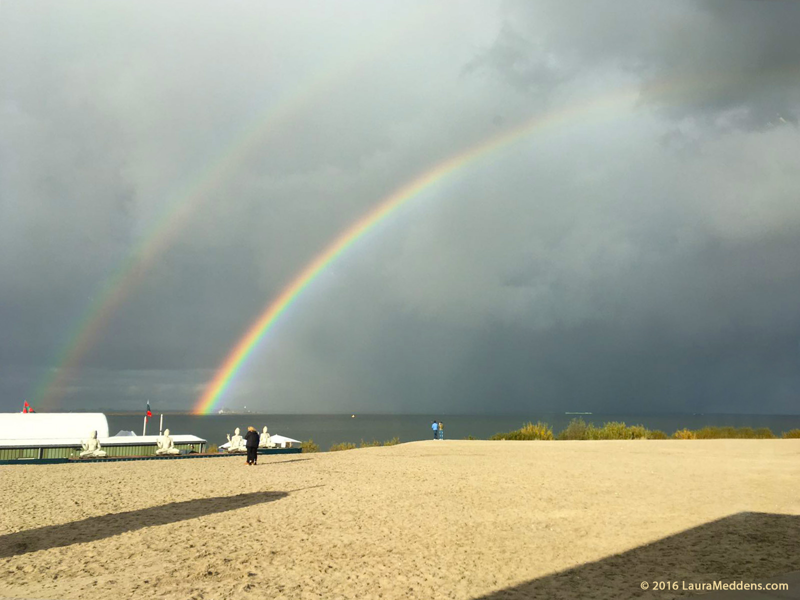 photo shows two parallel rainbows in the sky over Blijburg Beach in Ijburg, with t